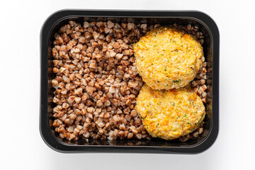 Golden baked patties rest on a flavorful base of cooked buckwheat. A meal ready to enjoy