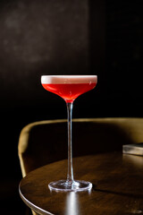 A beautifully crafted cocktail shines in its glass, inviting conversation and enjoyment at dusk