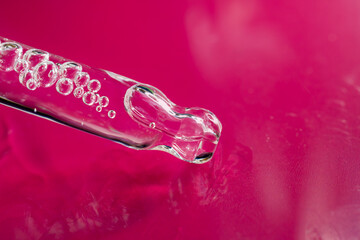 An eyedropper with a drop of oil or a cosmetic product for face and body. Natural organic cosmetics. The concept of body care.