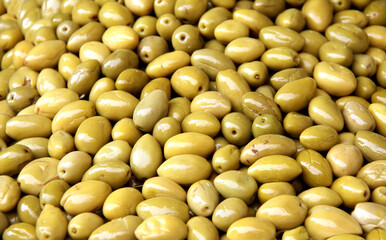 Green pickled olives on a traditional Moroccan market, Rabat, Morocco. Freshly preserved olives at a typical Moroccan bazaar. The verdant, brined olives are on display at outdoors oriental souk