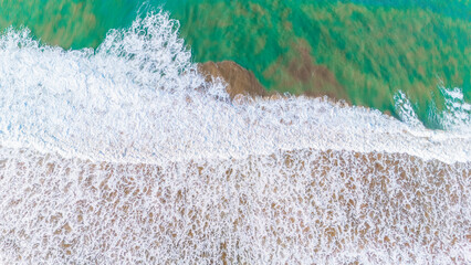 Aerial View Of Ocean Waves Creating Textures on the Shore Perfect for Travel and Holiday Content