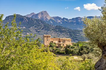 Villa in a lush green valley in a mountainous landscape