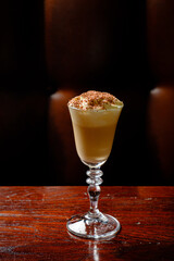 Sipping on a creamy dessert cocktail topped with chocolate shavings creates a cozy atmosphere