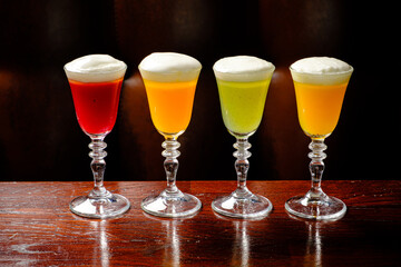 Brightly colored cocktails in unique glassware capture attention at a trendy evening gathering