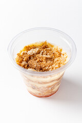 A delightful dessert features layers of cream, crumbs, and sweet toppings, inviting indulgence