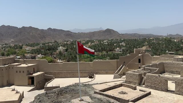Bahla Fort in Oman with waving national flag