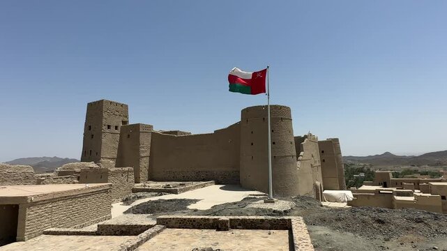 Bahla Fort in Oman with waving national flag