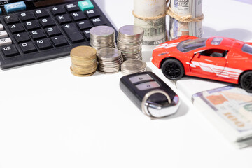 A visual representation of car ownership preparation—featuring a miniature car, scattered cash,...