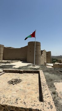 Bahla Fort in Oman with waving national flag