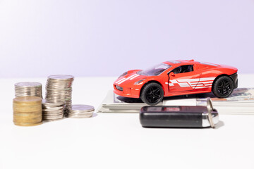 A visual representation of car ownership preparation—featuring a miniature car, scattered cash,...