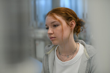 Plakat Teenage girl waiting for medical examination in hospital.