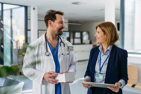 Female medical sales representative presenting medication to doctor
