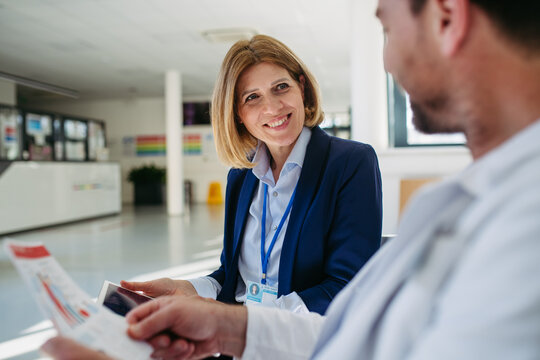 Pharmaceutical rep and doctor discussing drug samples and prescriptions
