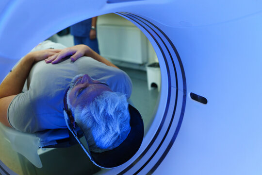 Male patient undergoing CT scan examination in hospital.
