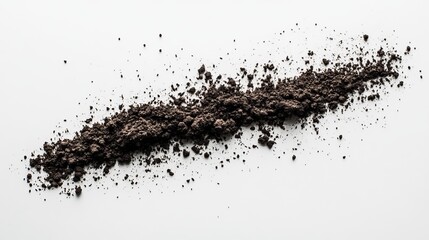 Dark brown powder scattered on a white background, forming an irregular line.  The texture is coarse and slightly grainy