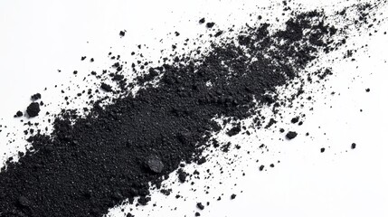 A swathe of dark, granular material scattered across a stark white background, exhibiting a textured, irregular distribution