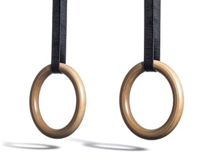 Two Wooden Gymnastic Rings Suspended With Black Straps On White Background
