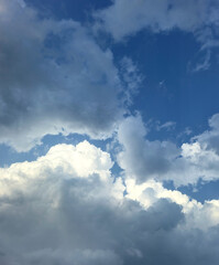 Summer blue sky cloud gradient light white background. Beauty clear cloudy sky. Sun shining through the puffy clouds. Beautiful sunny dynamic sky. Background with clouds on blue. Art of clouds