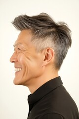 Fototapeta premium A man with natural beauty and a confident stance. Pure white solid background. Elegant men's two-block cut haircut - midlife asian man with short hair. Idea layout of style for aging men.