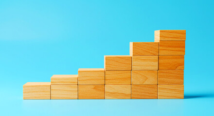 A staircase made of wooden blocks on a blue background representing growth and achievement concept
