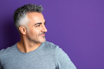 Fototapeta premium A confident and poised man in a professional setting. Purple solid background. Creative drawing of style for aging men. Modish men's buzz cut haircut - midlife arabian man with curly hair.