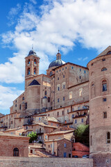 Cityscape of Italian town Urbino with majestic Palazzo Ducale. Palazzo Ducale Castle of the Dukes of Urbino, Italy