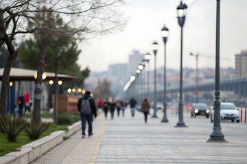 Blurry city walkway with pedestrians and streetlights
