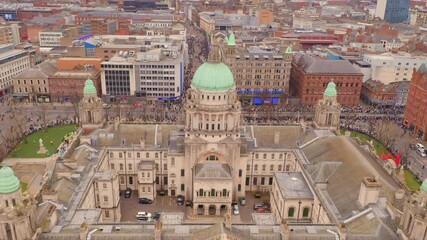 Dynamic aerial shot of St. Patrick's parade preparations on Belfast City Hall grounds