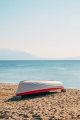 White lifeboat at Aegean sea shoreline in Strymonian gulf