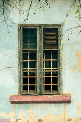 Old broken wooden window of an ruined house