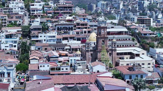 Aerial Mexico Puerto Vallarta neighborhood church circle fas 4K. Mexican beach resort city Pacific Ocean. International tourist destination. Tourism is economy. Outdoor luxury recreation. Cruise port.