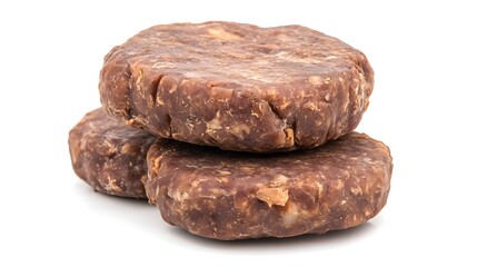 Photograph of three rustic, irregularly shaped chocolate-colored protein balls stacked together on a white background.