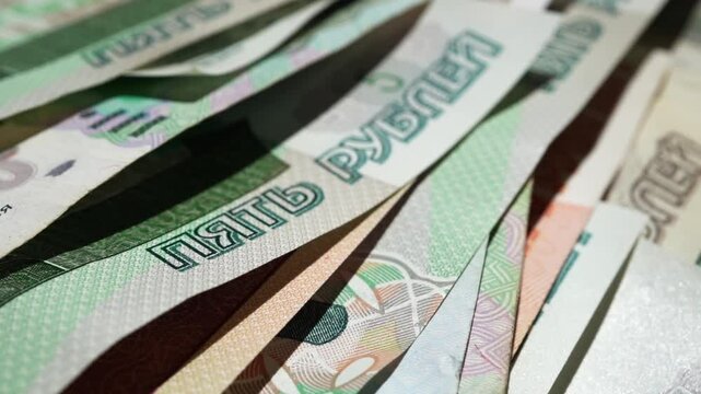 Paper banknotes of Russian rubles of different denominations in a stack close-up