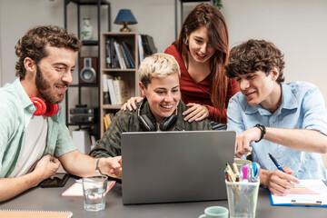 Young diverse creative team brainstorming together on laptop in modern home office