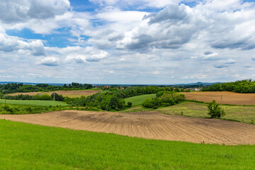Rural area in western Serbia. Fields and hills and mountains on the horizon.