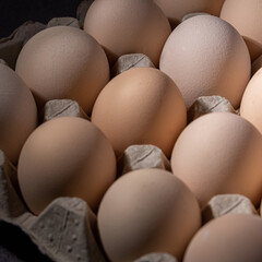 Brown eggs stacked in rows.Group of Fresh white Eggs in a cardboard cassette. Organic food from nature good for health.