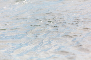 The water is calm and clear, with ripples that create a sense of tranquility