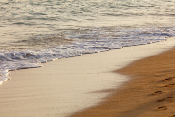 The ocean waves are crashing onto the shore