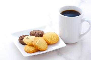 Delicious Cookies on white plate with cup of Coffee
