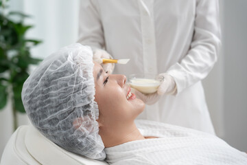 Beautiful woman receive spa and treatment skin of face. face of a healthy woman apply cream....