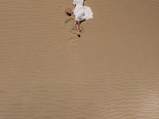 Aerial View of Woman Relaxing in Desert Sand