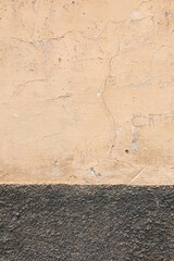 Yellow wall with rough grey base