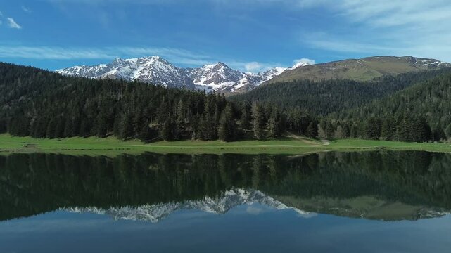 Aerial view of Lac de Payolle in the pyrenees, also known as little canada from the locals. It is located in the communes of Campan and Arreau of the Hautes-Pyr&eacute;n&eacute;es department. Dolly Move upward.