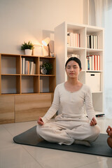 Teenage asian girl meditating in a calm and cozy home environment