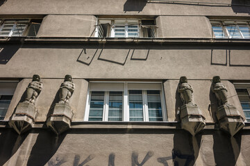 Decorative statues by the windows of the building