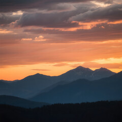 Obraz premium Sunset over mountain range with warm golden tones, dramatic clouds, scenic landscape, serene nature, breathtaking view, peaceful twilight sky