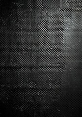 Close-up view of a perforated metal surface with small circular holes creating a textured pattern, lit to emphasize contrast and depth