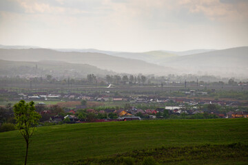 Obraz premium Small town in misty sunset, after rain.
