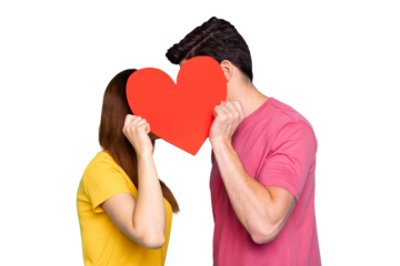 Profile side view portrait of his he her she nice couple holding in hands hiding behind big large heart symbol kissing secretly isolated over bright vivid shine vibrant green turquoise background