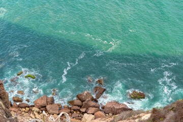 Fototapeta na wymiar Rocky coastline with turquoise ocean waves